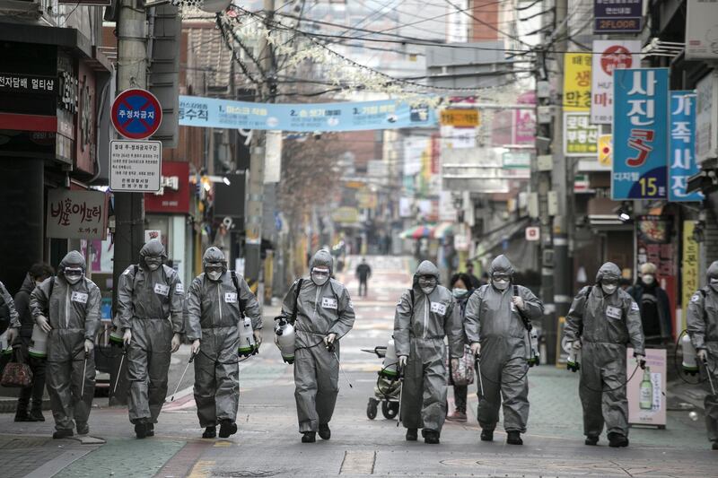 South Korean soldiers, in protective gear, disinfect the Eunpyeong district against the coronavirus in Seoul, South Korea. Getty Images