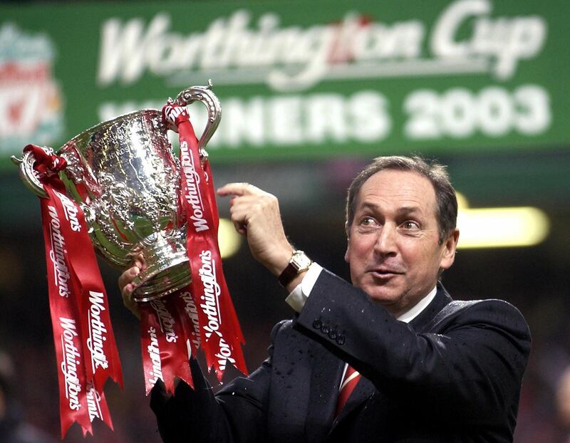 In this file photo taken on March 2, 2003 Liverpool's French manager Gerard Houllier holds the cup aloft celebrating victory over Manchester United in the Worthington cup final at the Millenium stadium in Cardiff.  Ex-Liverpool manager Gerard Houllier has died at the age of 73, it was announced on December 14, 2020.  AFP
