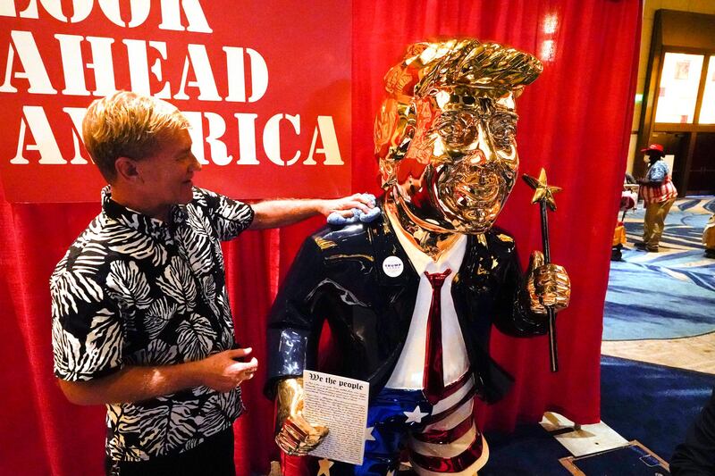 Tommy Zegan says his golden Donald Trump statue is so popular with those attending the Conservative Political Action Conference that he has to wipe fingerprints off the figure every hour. AP Photo