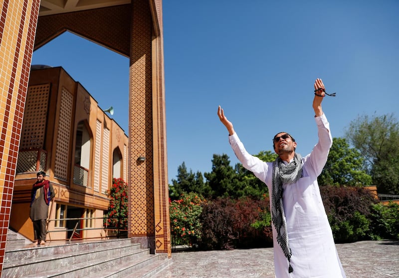 An Afghan man gestures after the prayers during Eid Al Fitr at a mosque in Kabul, Afghanistan. REUTERS