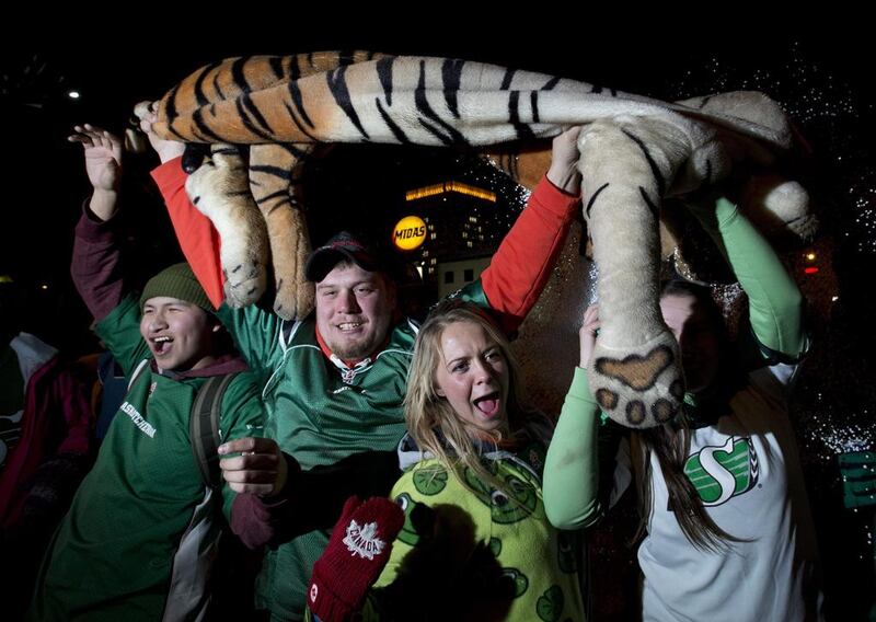 Saskatchewan Roughriders fans hoist a stuffed tiger in celebration of their victory. Frank Gunn / AP Photo / The Canadian Press