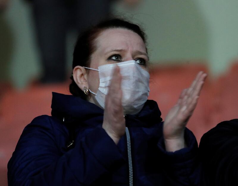 A fan is seen wearing protective face mask during the Vysheyshaya Liga match between  Dynamo Brest and Isloch Minsk. Reuters