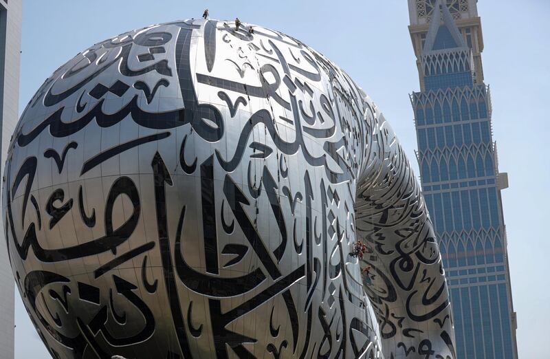 Labourers work on the under-construction Museum of the Future in Dubai. EPA