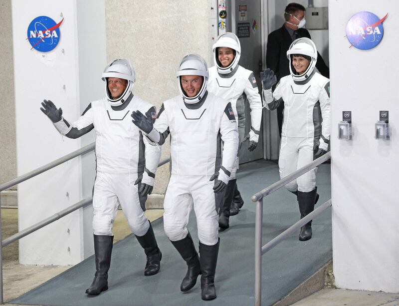 Crew-4 mission astronauts (from L) Bob Hines, Kjell Lindgren, Jessica Watkins and Samantha Cristoforetti of the European Space Agency walk out of the Neil A.  Armstrong Operations and Checkout Building en route to launch complex 39A at the Kennedy Space Center in Florida on April 27, 2022. AFP