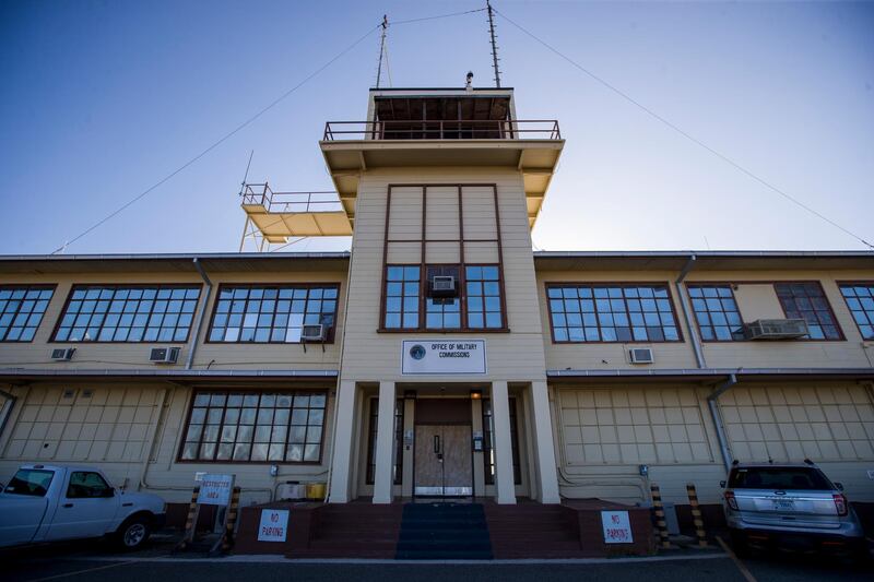 In this photo reviewed by U.S. military officials, the Office of Military Commissions building used for Periodic Review Board hearings is seen, Thursday, April 18, 2019, in Guantanamo Bay Naval Base, Cuba. The Pentagon has announced plans to move ahead with a military trial for three men held at the U.S. base at Guantanamo Bay, Cuba, who are suspected of involvement in bombings in Indonesia in 2002 and 2003. (AP Photo/Alex Brandon)