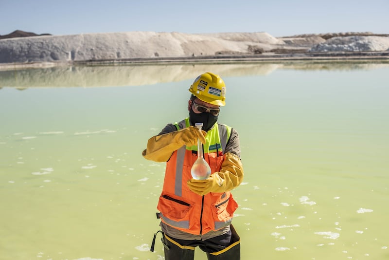 A mine worker takes water samples from a brine pool at the Albemarle lithium mine in Calama. Bloomberg