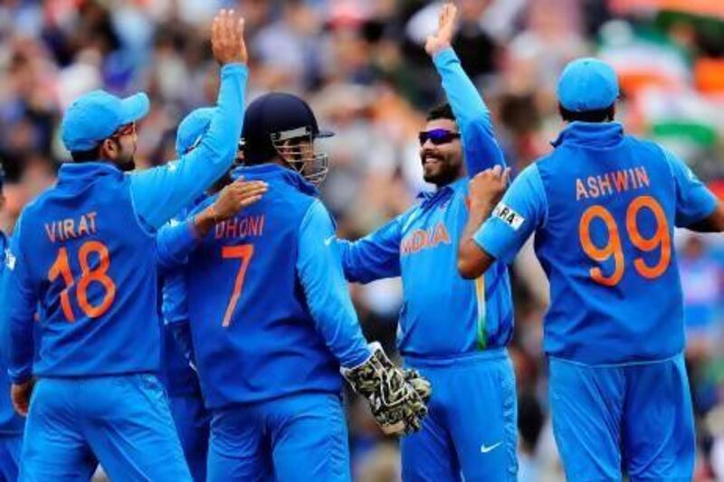 India's Ravindra Jadeja, second from right, celebrates the wicket of West Indies' Ramnaresh Sarwan who was caught by India's MS Dhoni for one run during their 2013 Champions Trophy match.