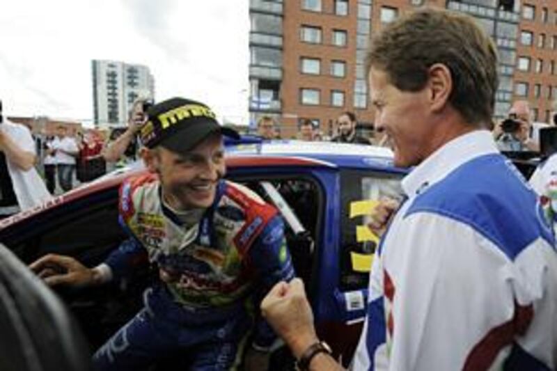 The Finnish driver Mikko Hirvonen is greeted by Malcolm Wilson after winning the Rally of Finland, his third successive win.