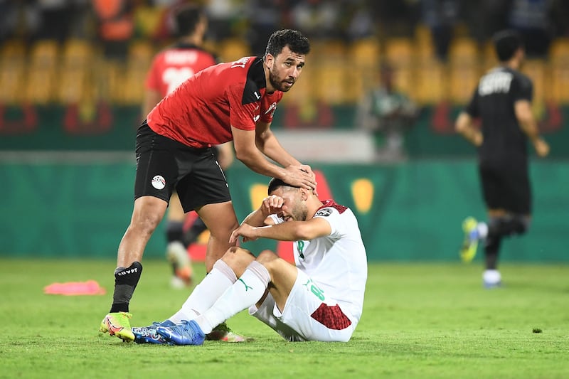 Egypt's Trezeguet commiserates Morocco forward Tarik Tissoudali after the match. AFP
