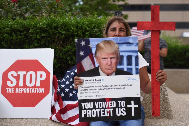 FILE - In a June 16, 2017 file photo, Amal Hana protests in Detroit. A family member was detained during Immigration and Customs Enforcement raids of primarily Chaldean immigrants and is facing deportation. A federal judge in Detroit is mulling whether to release hundreds whose deportations to Iraq were suspended but remain in custody. U.S. District Judge Mark Goldsmith, who will hear arguments on Wednesday, Dec. 20, 2017, blocked the deportation of 1,400 people in July to allow time to challenge their removal in immigration court. (Tanya Moutzalias/The Ann Arbor News-MLive.com Detroit via AP)