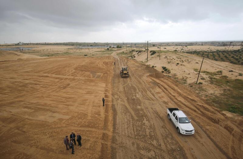 Palestinian municipality workers and Health Ministry personnel stand at the construction site of a field hospital to house coronavirus patients in Rafah in the southern Gaza Strip. AFP