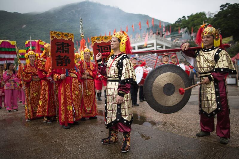 Worshippers in traditional costumes parade at a temple dedicated to the Chinese Goddess of the Sea Tin Hau in Hong Kong, China. Jerome Favre / EPA