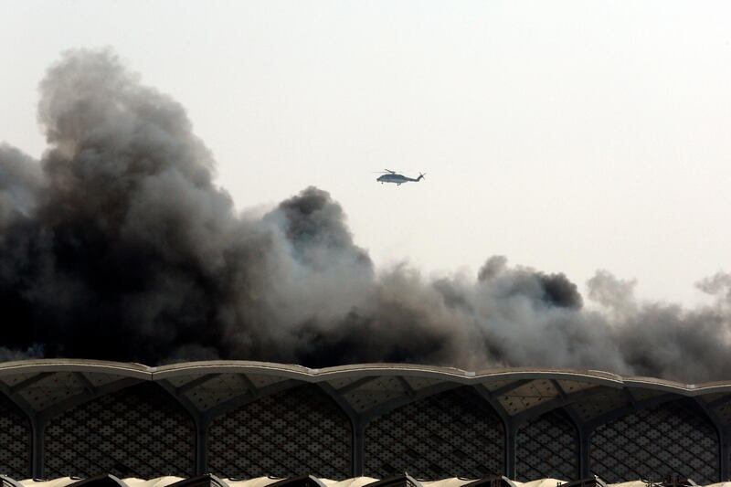 A helicopter hovers over the Haramain high-speed rail station after a fire broke out in Jeddah.  EPA