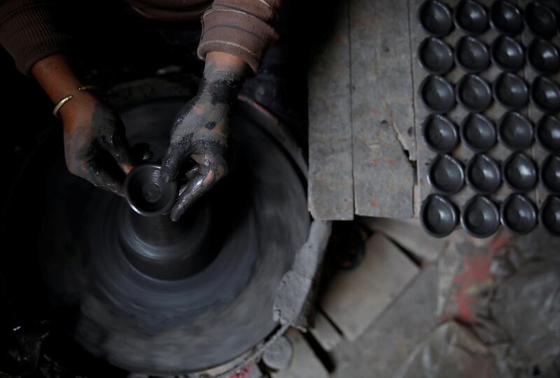 A potter makes earthenware oil lamps or "Diyo" used to decorate temples and homes ahead of Tihar festival, also called Diwali, the Hindu festival of lights, in Bhaktapur, Nepal October 20, 2019. Reuters