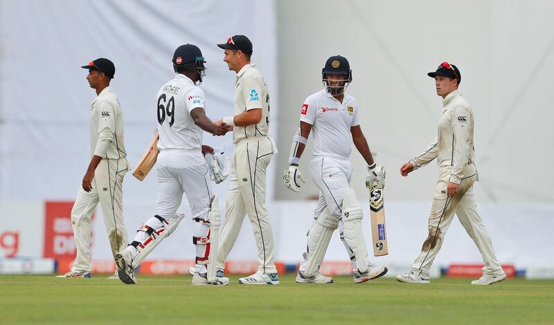 Sri Lanka's Angelo Mathews, second left, and Dimuth Karunaratne, second right, along with New Zealand's Jeet Raval, left, Tim Southee, center, and Gary Nichols leave the field after the play was stopped due to bad light during the first day of the second test cricket match between Sri Lanka and New Zealand in Colombo, Sri Lanka, Thursday, Aug. 22, 2019. (AP Photo/Eranga Jayawardena)