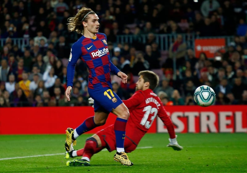 Barcelona's Antoine Griezmann, left, tries to beat Levante's goalkeeper Aitor Fernandez. AP