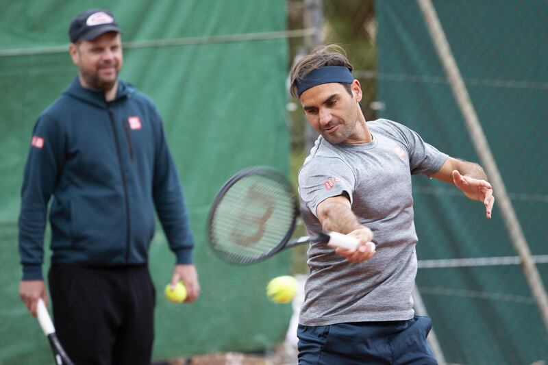 Roger Federer and coach Severin Luethi during training. EPA