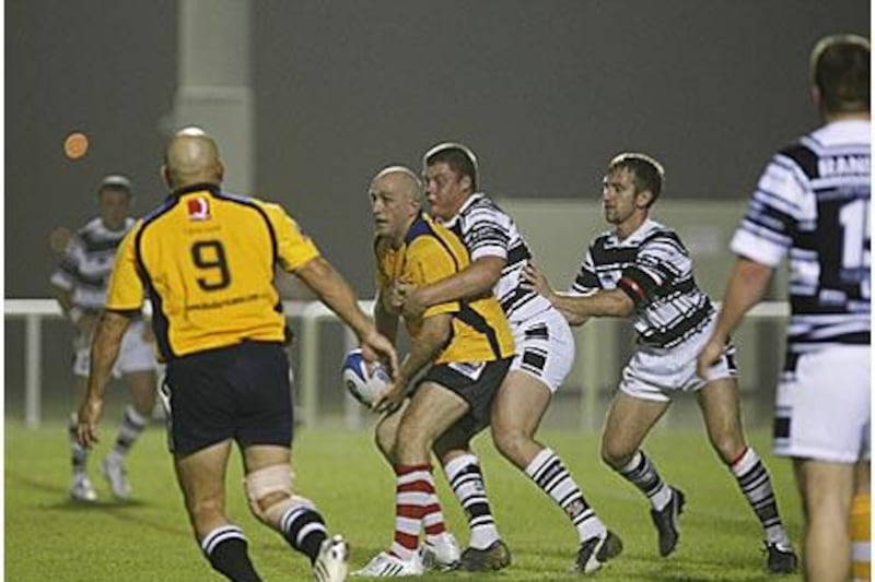 David Wallis of the UAE Falcons tries to offload the ball to a teammate during Friday's game against the Saddleworth Rangers in Dubai.