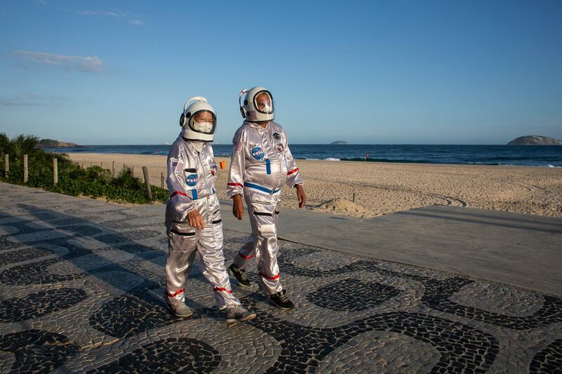 Accountant Tercio Galdino and wife Alicea, dressed in their astronaut costumes, walk along Ipanema beach in Rio de Janeiro, Brazil, amid the coronavirus pandemic. AP Photo