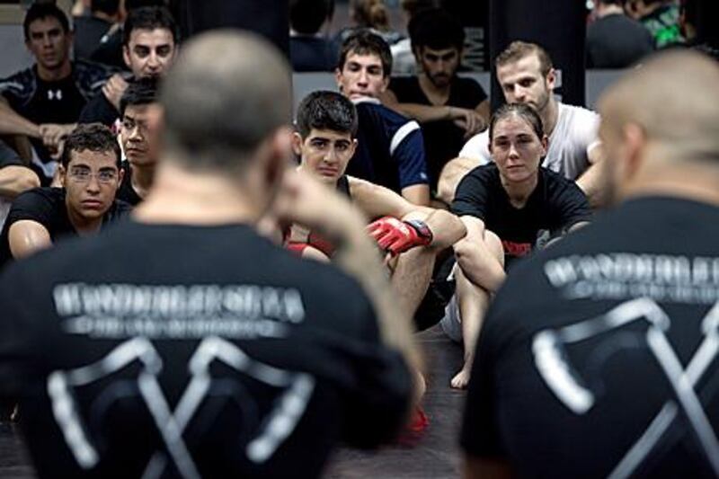 Participants listen to mixed martial arts fighter Wanderlei ‘The Axe Murderer’ Silva, right, at The Contender, in Dubai.