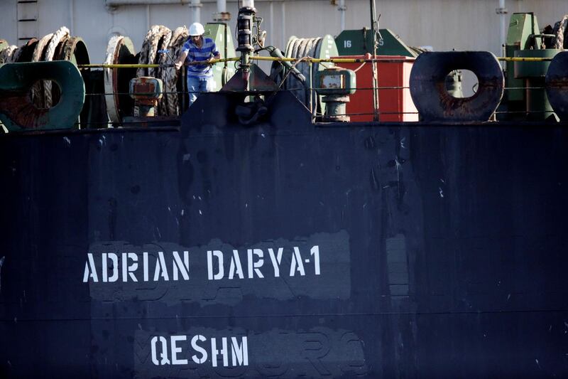 REFILE - CORRECTING GRAMMAR  A crew member takes pictures with a mobile phone of Iranian oil tanker Adrian Darya 1, previously named Grace 1, as it sits anchored after the Supreme Court of the British territory lifted its detention order, in the Strait of Gibraltar, Spain, August 18, 2019. REUTERS/Jon Nazca