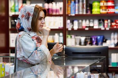 An Iranian woman shops at a drugstore at the Nikan hospital in Tehran. The Iranian economy is expected to go into recession next year. AFP 
