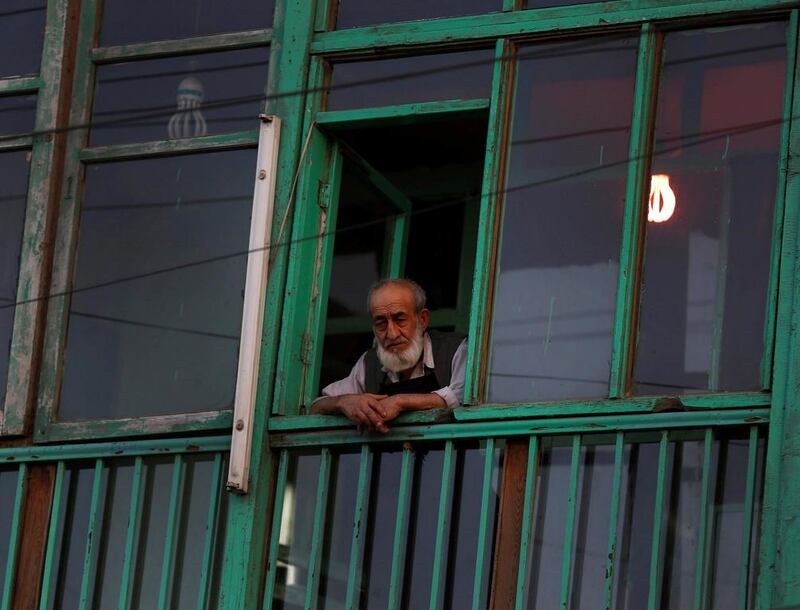 A man looks out of the window of a restaurant in Kabul on June 12, 2014. Ahmad Masood / Reuters