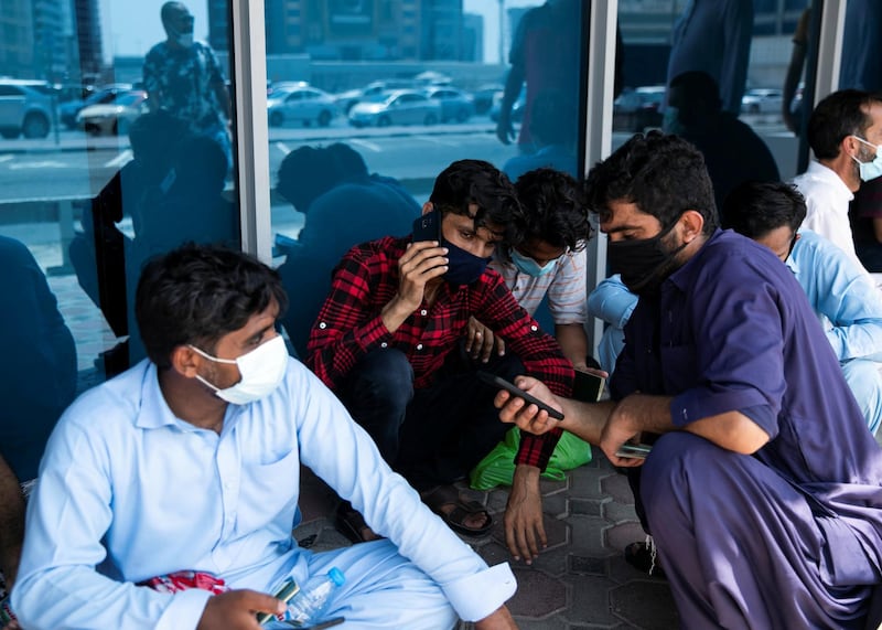 DUBAI, UNITED ARAB EMIRATES. 18 June 2020. Pakistani citizens who live in Dubai line up outside Dnata. They’ve received a confirmation call from the consulate regarding their repatriation flights. Some are flying back tonight.(Photo: Reem Mohammed/The National)Reporter:Section:
