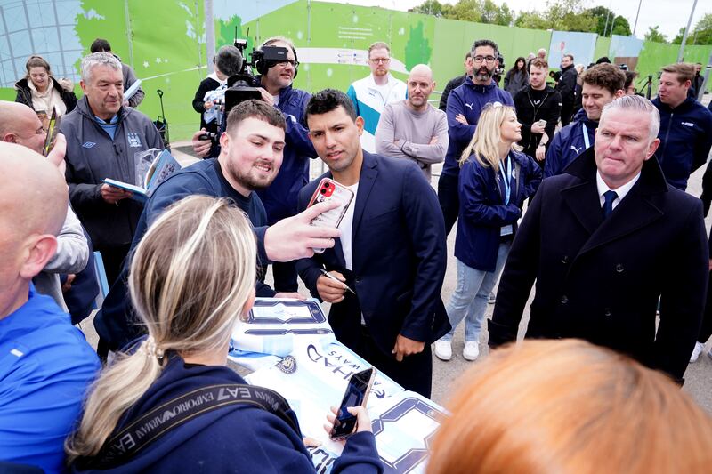 Sergio Aguero poses for picture with Manchester City supporters outside the Etihad Stadium. AP