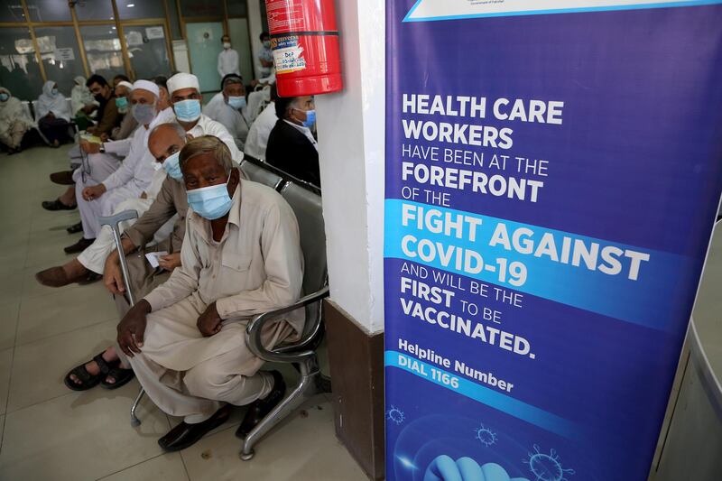 People wait their turn to receive the second shot of the Sinopharm Covid-19 vaccine at a vaccination centre, in Peshawar, Pakistan, on April 21, 2021. AP Photo