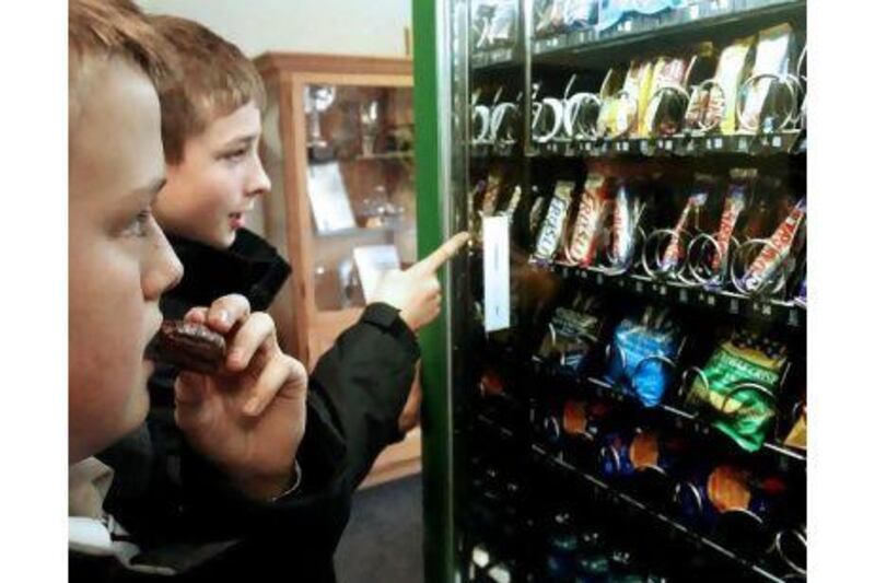 Daniel Kennedy, left, 14, and Tom Lofthouse, 13, in Dunstable, Britain, choose a snack, which researchers warn could lead to obesity.