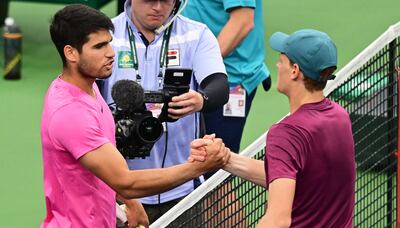 Carlos Alcaraz greets Jannik Sinner at the net after their Indian Wells semi-final match. AFP
