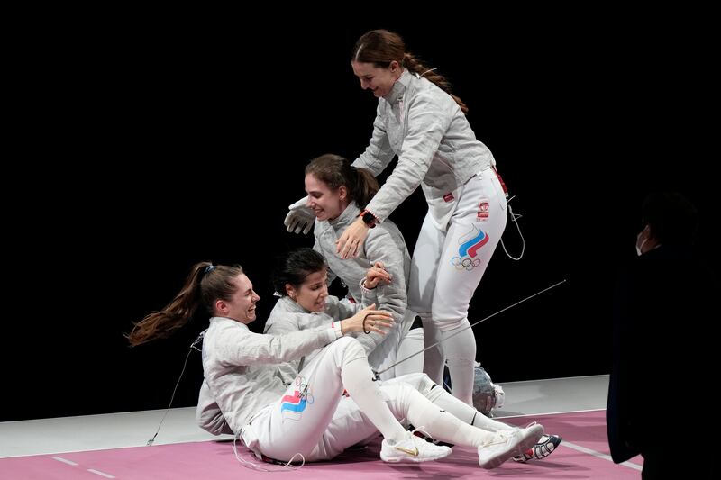 Fencers of the Russian Olympic Committee celebratesafter defeating France at the women's Sabre team final.