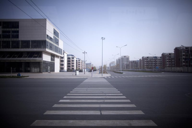 Empty structures stand in the new district of Kangbashi in Ordos, Inner Mongolia, China, on Saturday, April 30, 2011. Designed for 300,000 people, Kangbashi, the new urban center of Ordos prefecture, may have only 28,000 residents, Bank of America-Merrill Lynch said last year. Photographer: Nelson Ching/Bloomberg