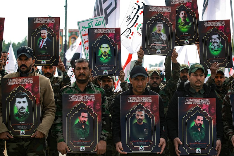 Members of Iraq's Hashd Al Shaabi (Popular Mobilisation), carry portraits of people killed in US strikes in western Iraq. AFP 