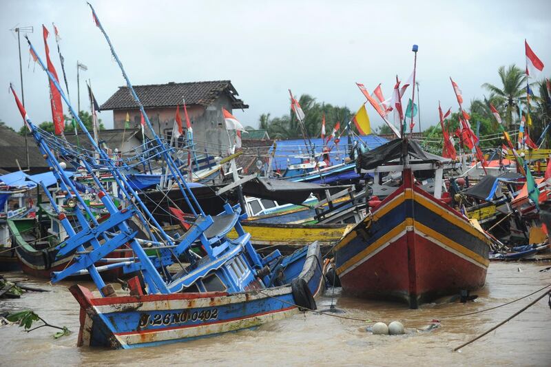 Traditional fishing boats are seen damaged in Teluk village. AFP