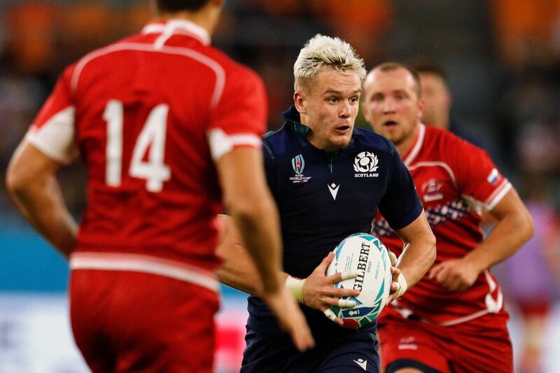 Scotland's wing Darcy Graham (C) runs with the ball on his way to making a pass to Scotland's scrum-half George Horne for a try during the Japan 2019 Rugby World Cup Pool A match between Scotland and Russia at the Shizuoka Stadium Ecopa in Shizuoka on October 9, 2019. / AFP / Adrian DENNIS
