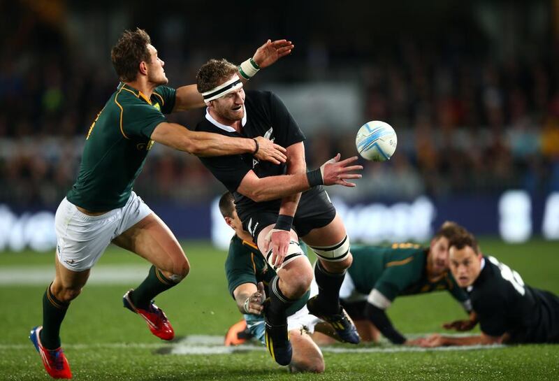 Kieran Read, centre, of the All Blacks offloads in the tackle of JJ Engelbrecht of the Springboks during a Rugby Championship match between New Zealand and South Africa on Saturday. Read finished with two tries and the All Blacks went on to win, 29-15. Phil Walter / Getty Images