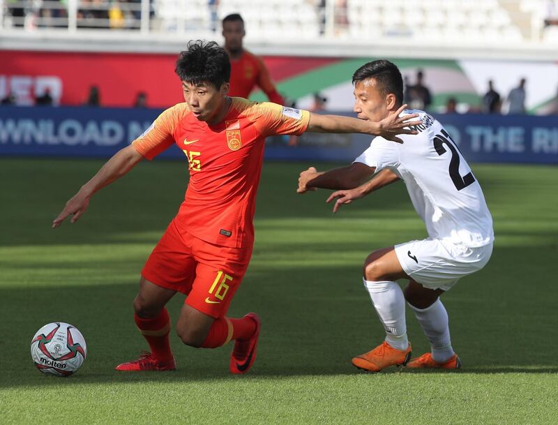 Kyrgyzstan's midfielder Farhat Musabekov tussles for the ball with China's midfielder Jingdao Jin. AFP