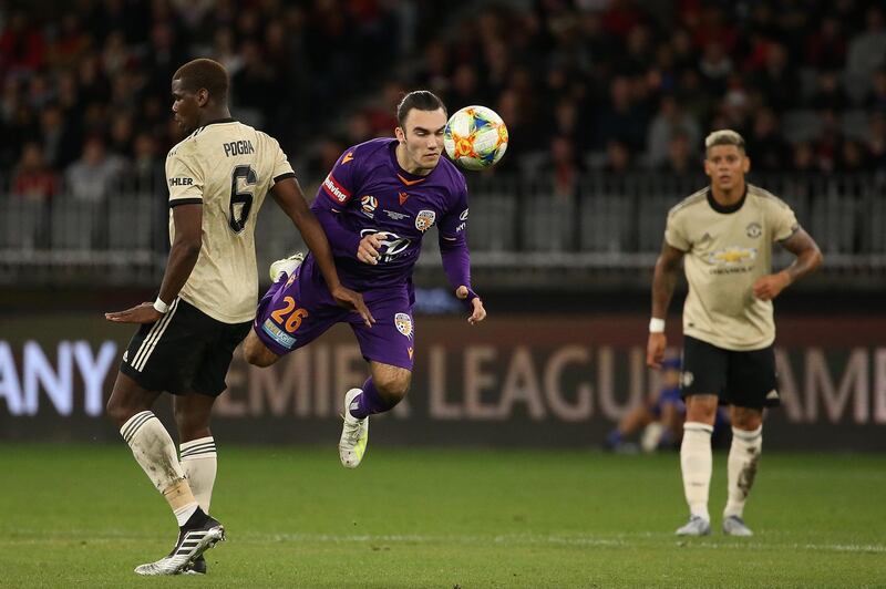 Perth Glory's Nick D'Agostino makes a diving header against Manchester United. Getty Images