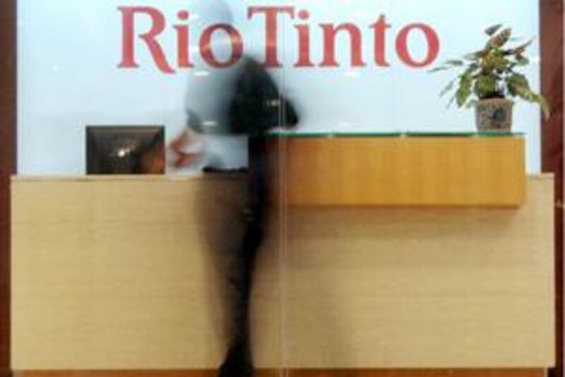 An employee walks past the reception area at the Rio Tinto Limited Shanghai Representative Office in Shanghai August 12, 2009. Chinese prosecutors have formally arrested four employees of Anglo-Australian mining giant Rio Tinto on suspicion of obtaining commercial secrets and bribery, the official Xinhua news agency reported on Wednesday.         REUTERS/Aly Song (CHINA POLITICS CRIME LAW) *** Local Caption ***  SHA102_CHINA-RIO-_0812_11.JPG *** Local Caption ***  SHA102_CHINA-RIO-_0812_11.JPG