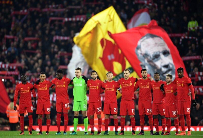 Liverpool players observe a minute’s silence prior to the match. Laurence Griffiths / Getty Images