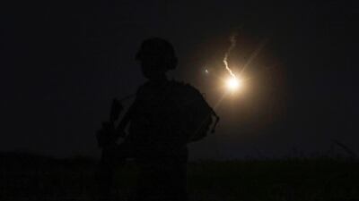 The silhouette of an Israeli soldier is outlined in the sky by a flare fired to search for a rocket that landed in the Israeli annexed Golan Heights. AFP