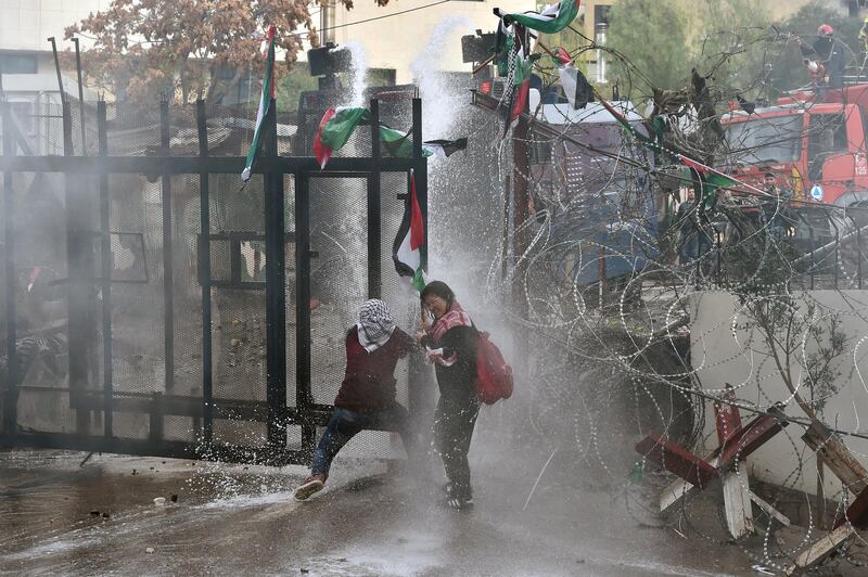 Lebanese riot policemen turn water jets on protesters trying to break through barricades near the US embassy in Awkar, east of Beirut, on December 10, 2017. The demonstrators were protesting against US president Donald Trump's decision to recognise Jerusalem as Israel's capital and to move the US embassy there from Tel Aviv. Wael Hamzeh / EPA