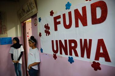 In this Sept. 3, 2018 file photo, Palestinian refugee students stand outside a classroom as they wait to attend a ceremony to mark the return to school of a new year at one of the UNRWA schools, in Beirut, Lebanon. AP