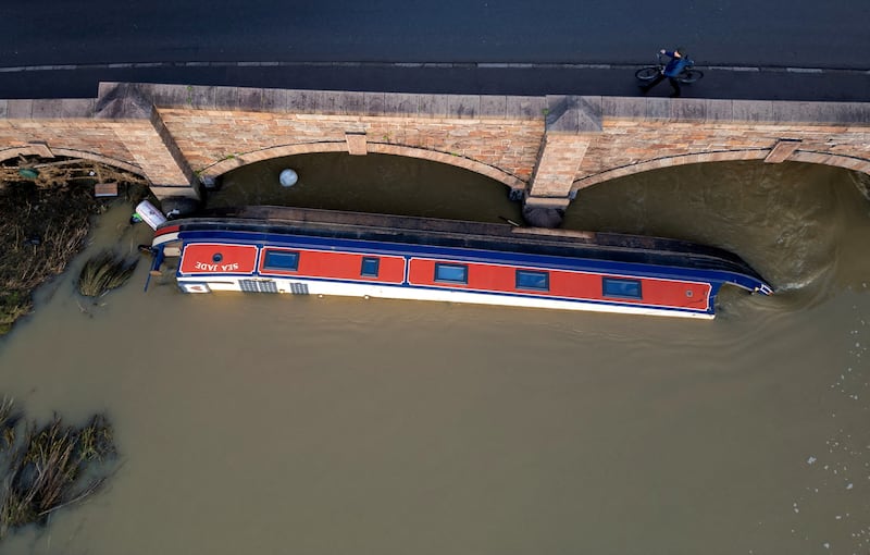 A barge on its side in the Soar river after being swept away in flooding in the aftermath of Storm Henk. Reuters