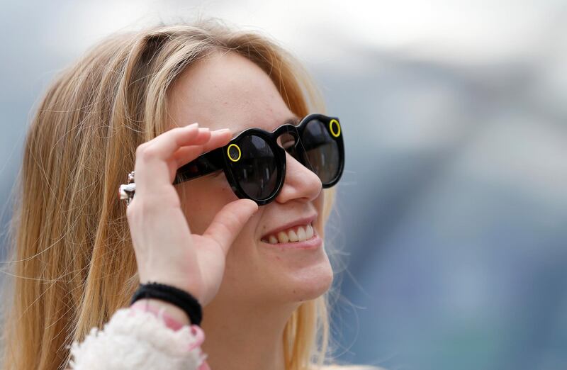 PARIS, FRANCE - JUNE 09:  A young woman poses with the 'Spectacles'-glasses of the company Snap Inc on June 09, 2017 in Paris, France. At the press of a button, owners can take up to ten seconds of videos with glasses that can then be downloaded on Snapchat application. The camera is positioned in the left arm of the glasses. On the right side, a light turns on when shooting. The camera-sunglasses is now sold in France in vending machines named "Snapsbots"since June and costs 149.99 euros.  (Photo by Chesnot/Getty Images)