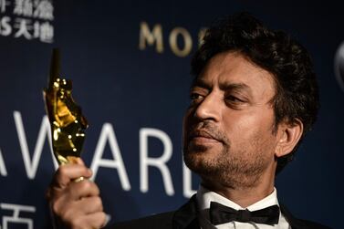 (FILES) In this file photo taken on March 27, 2014 Best Actor winner Irrfan Khan poses with his trophy during the Asian Film Awards in Macau. Acclaimed Indian actor Irrfan Khan, whose international movie career included hits like "Slumdog Millionaire", "Life of Pi" and "The Amazing Spider-Man", has died aged just 53, his publicist said on April 29, 2020. / AFP / Philippe LOPEZ