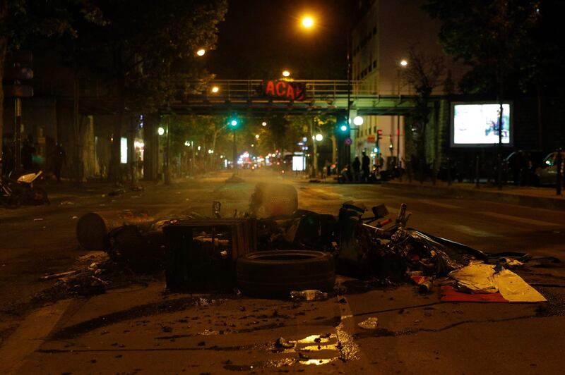 A destroyed motor scooter and other burnt waste have been left behind by protesters at Porte de Clichy, in the northwest of Paris, on June 2, 2020 following a demonstration against police violence and in memory of late US citizen George Floyd who died a week before after a Minneapolis police officer knelt on his neck. Several US cities have deployed the guard in the face of angry protests against police brutality following the killing of unarmed black man George Floyd by police during an arrest in Minneapolis last week. / AFP / GEOFFROY VAN DER HASSELT
