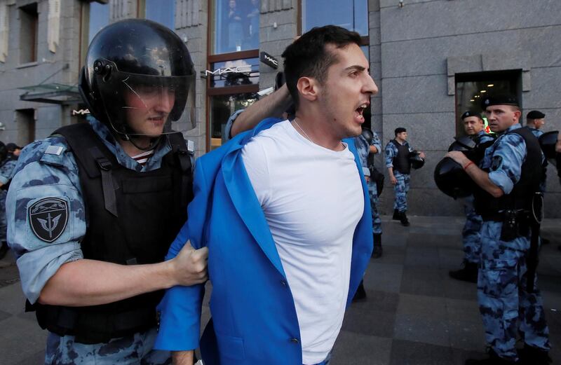 Law enforcement officers detain a man during a rally calling for opposition candidates to be registered for elections to Moscow City Duma, the capital's regional parliament, in Moscow, Russia July 27, 2019. REUTERS/Maxim Shemetov